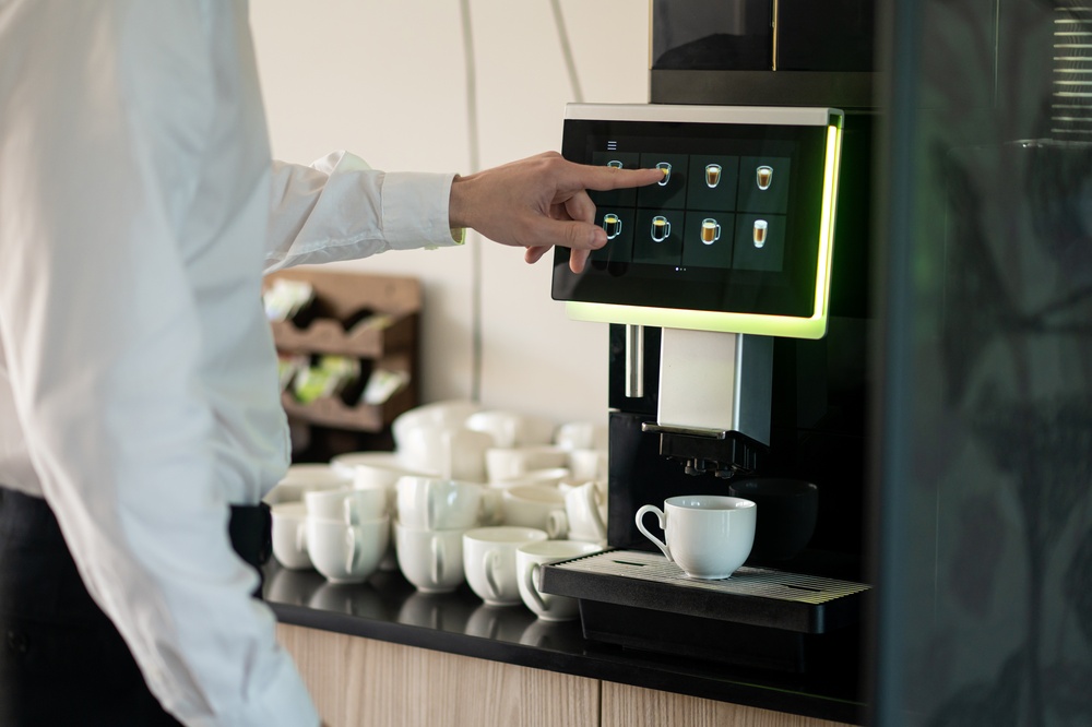 Man,In,The,Office,Using,Coffee,Machine,And,Making,Cappuccino